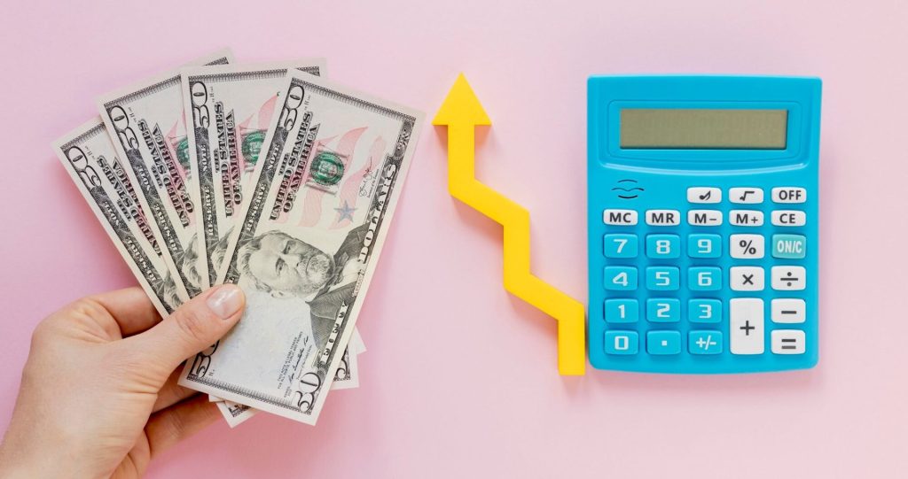 Money and calculator indicating the increasing cost of obtaining a divorce
