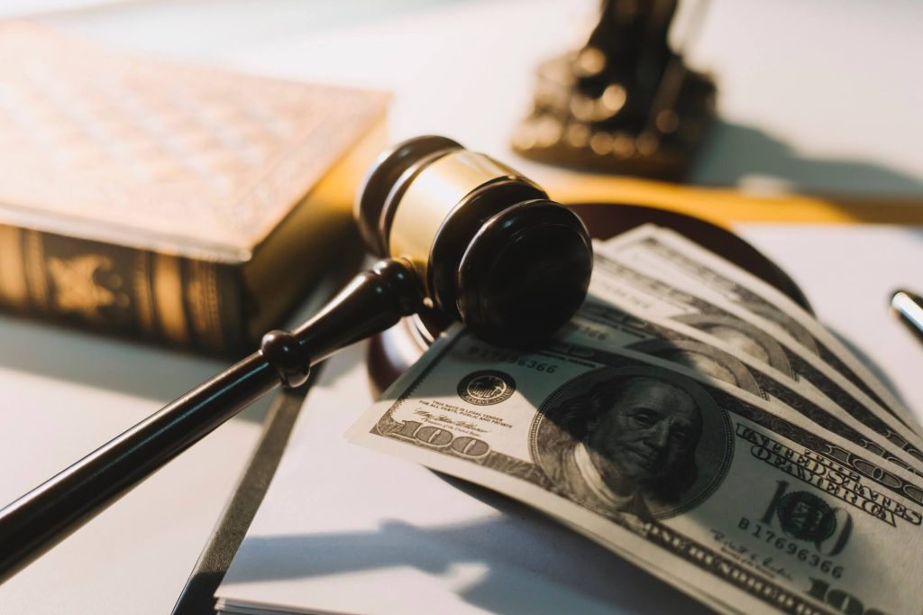 The judge's gavel lies on the table next to the divorce filing fees