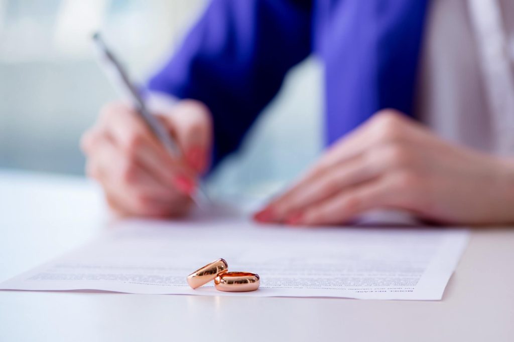 Woman filing divorce papers while sitting at the table
