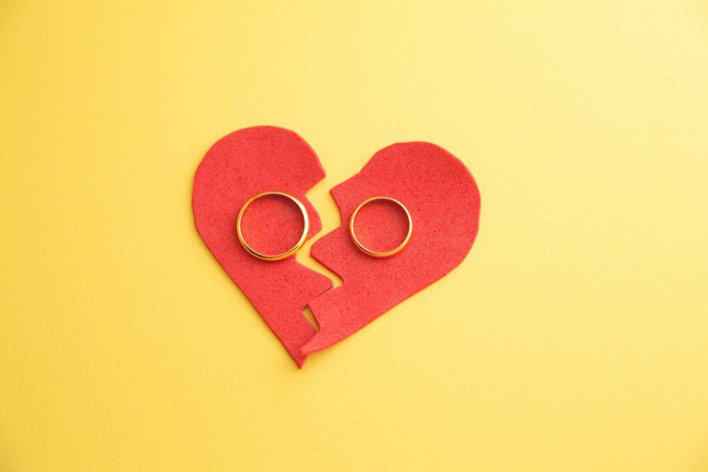 Broken heart with wedding rings during divorce process in MA
